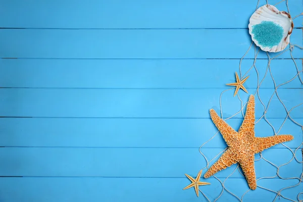 Starfish and shell on blue wooden background, copy space — Stok fotoğraf