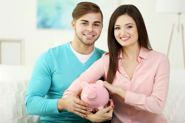 Happy couple sitting at home — Stock Photo, Image