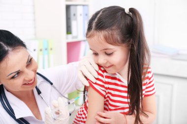Bir çocuğu muayene eden doktor. 