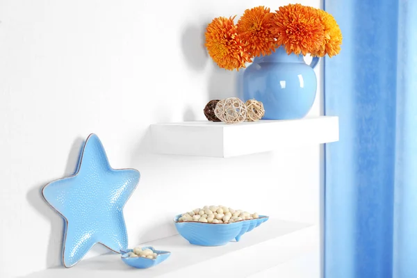 Pot avec fleurs et autres décorations sur une étagère dans la chambre — Photo