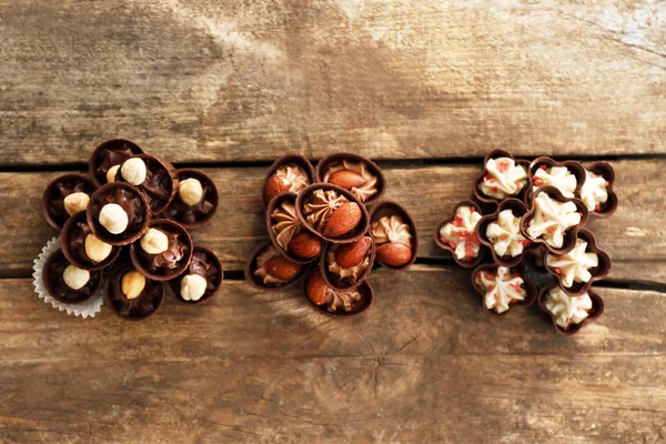 Composition of different chocolate candies on wooden background — Stock Photo, Image