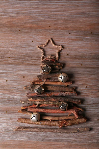 Christmas tree made of wooden branches on wooden table top view — Stock Photo, Image