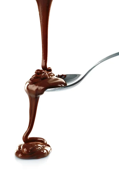 Melted chocolate pouring from a spoon — Stock Photo, Image