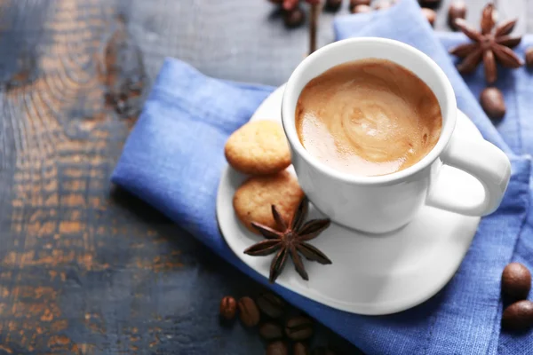 Xícara de café com especiarias em fundo de mesa de madeira — Fotografia de Stock