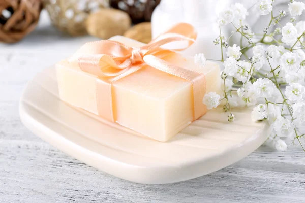 Soap with ribbon on dish — Stock Photo, Image