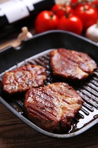 Geroosterd rundvlees filet op pan, op houten achtergrond — Stockfoto