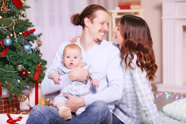 A szülők a baba közelében karácsonyfa — Stock Fotó
