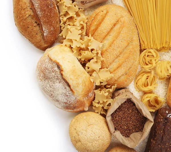 Composition des pains mélangés, des macaronis et des grains sur fond blanc — Photo