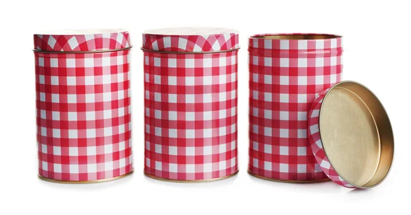 Três recipientes de lata quadriculados vermelhos e brancos, isolados sobre branco — Fotografia de Stock
