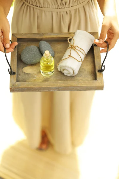 Hands with tray of spa products — Stock Photo, Image
