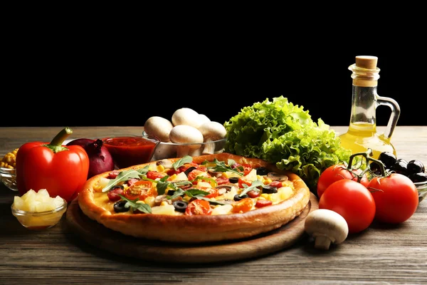 Delicious pizza with vegetables on black background — Stock Photo, Image