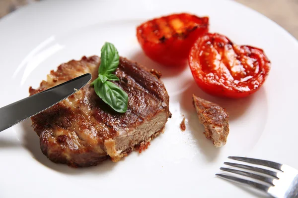 Roasted beef fillet on plate, on wooden background — Stock Photo, Image