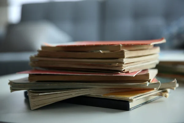 Pile of old books on white table. Focus on books and blurred background — Stock Photo, Image