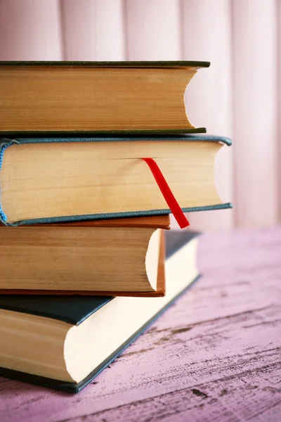 Pile of books on panel background — Stock Photo, Image