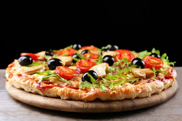 Läckra välsmakande pizza på svart bakgrund — Stockfoto