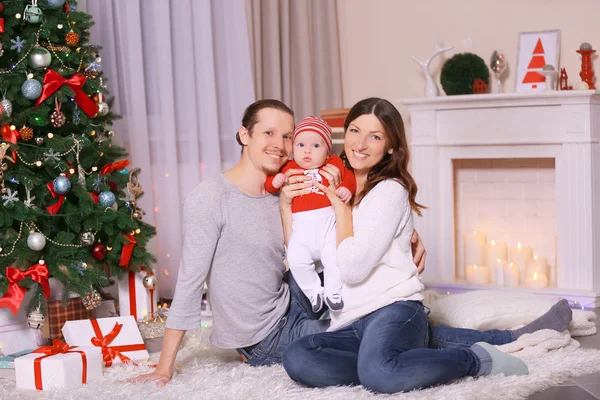 Parents with baby near Christmas tree — Stock Photo, Image