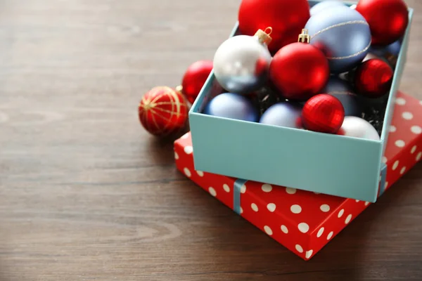 Boîte avec jouets de Noël sur fond en bois — Photo