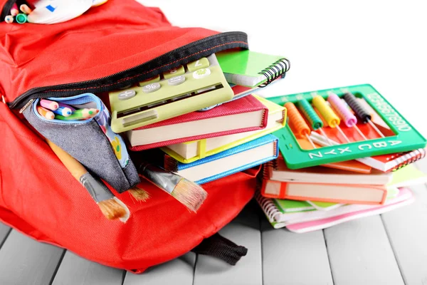 Red backpack full of stationery — Stock Photo, Image