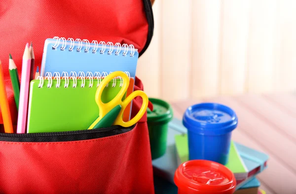 Red backpack full of stationery — Stock Photo, Image