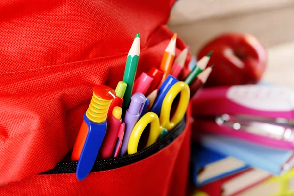 Red backpack full of stationery — Stock Photo, Image