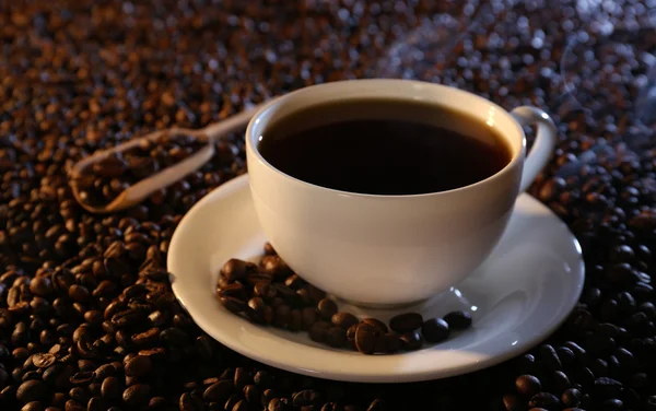 Tazza di caffè caldo su sfondo chicchi di caffè — Foto Stock