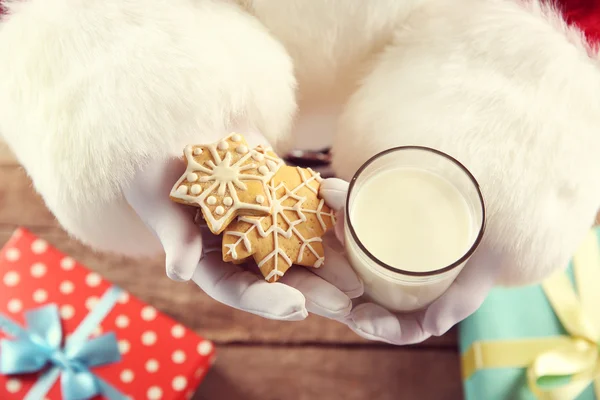 Christmas concept. Santa with glass of milk and cookies in hands, close up — Stock Photo, Image