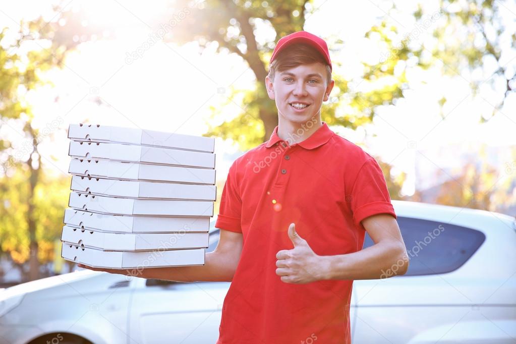 Delivery boy with pizza boxes