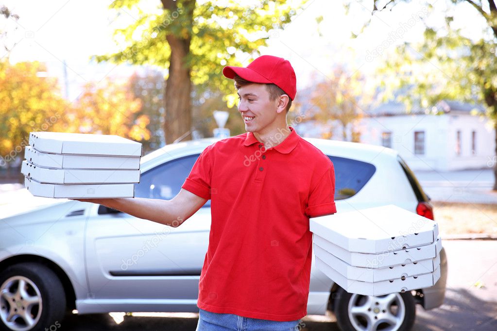 Delivery boy with pizza boxes