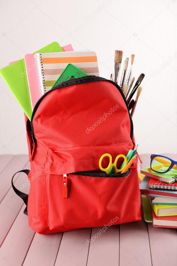 Red backpack full of stationery