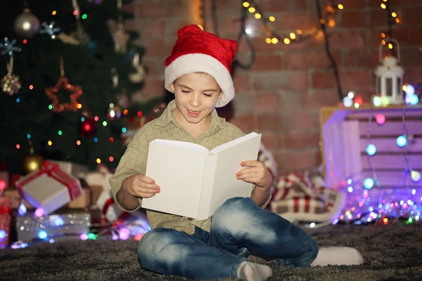 Liten pojke med boken sitter hemma — Stockfoto