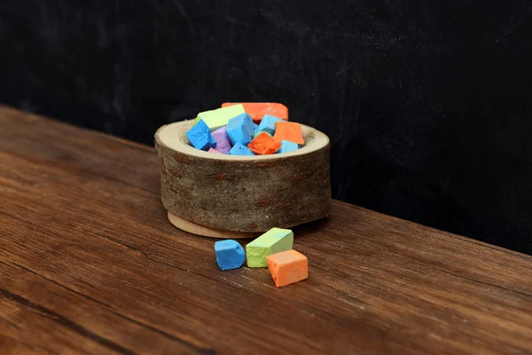 Wooden bowl of coloured chalk