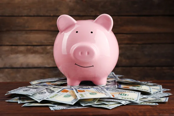 Pig money box and dollar banknotes