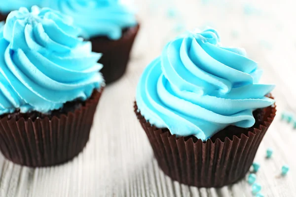 Blue cupcakes on wooden table — Stock Photo, Image