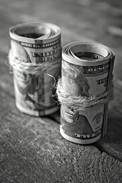 Dollars rolls on wooden table — Stock Photo, Image