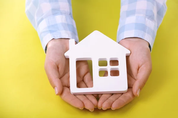 Female hands holding house — Stock Photo, Image