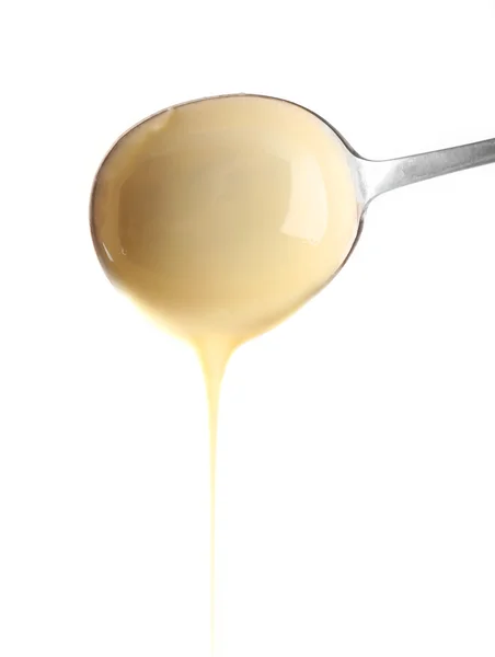 Condensed milk pouring — Stock Photo, Image