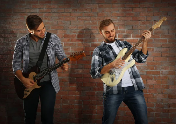 Young men playing guitars — Stock Photo, Image