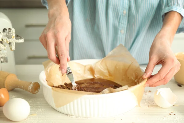 Woman is mixing dough — Stock Photo, Image