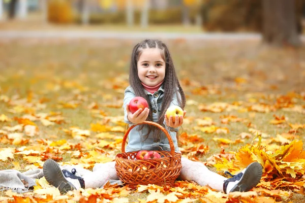 Beautiful little girl with apples — Stock Photo, Image