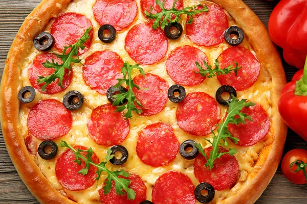 Tasty pizza with salami and red vegetables — Stock Photo, Image