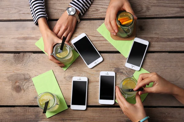 Four hands with smart phones — Stock Photo, Image