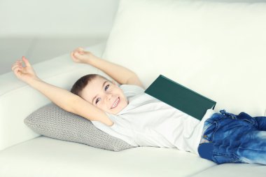 kanepede yatan kitap çocukla