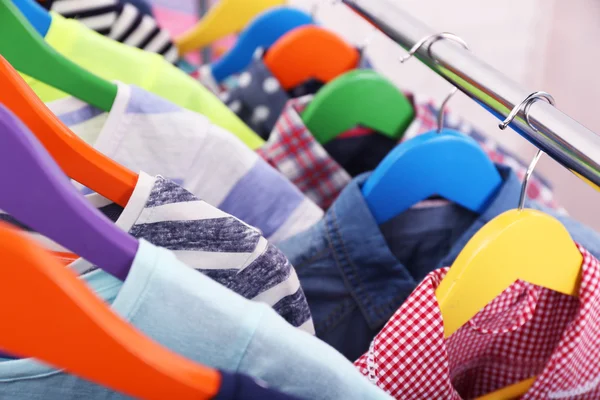 Children clothes on hangers — Stock Photo, Image