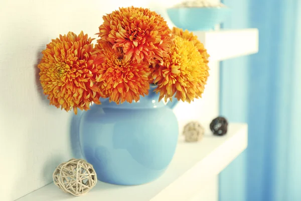 Jar with flowers on shelf — Stock Photo, Image