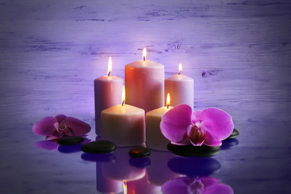 Top Angle View Burning Candles Purple Flowers Stone Blurred Background  Stock Photo - Download Image Now - iStock