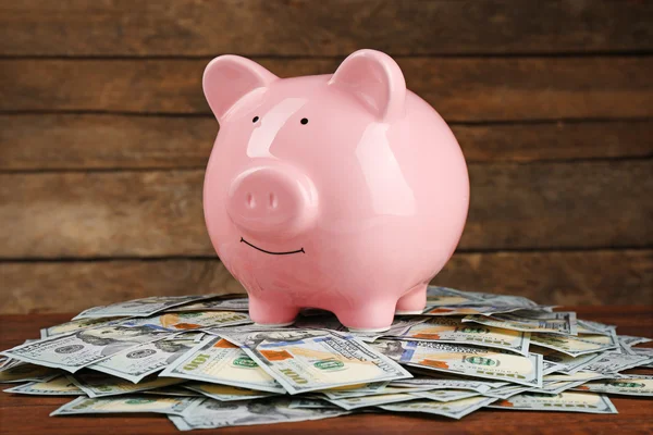 Pig money box and dollar banknotes — Stock Photo, Image