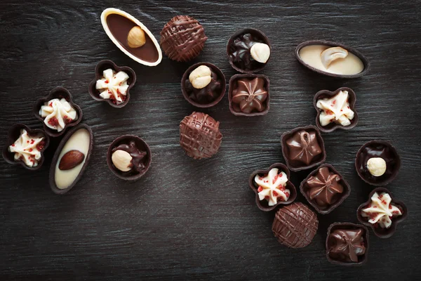 Σύνθεση της σοκολάτας καραμέλες σε ξύλινα φόντο — Φωτογραφία Αρχείου