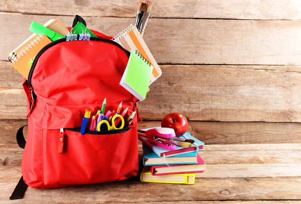 Red backpack with books and apple — Stock Photo, Image