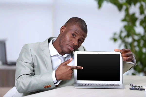 Handsome businessman with laptop — Stock Photo, Image