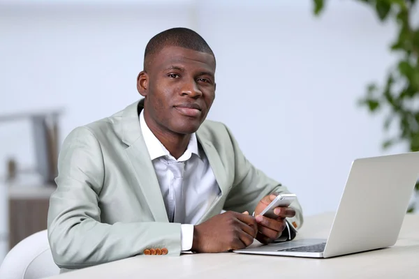 Handsome businessman with laptop — Stock Photo, Image